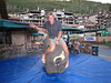 ussa > Cross country athlete Andy Newell gives the mechanical bull a shot (credit: Doug Haney/USSA)